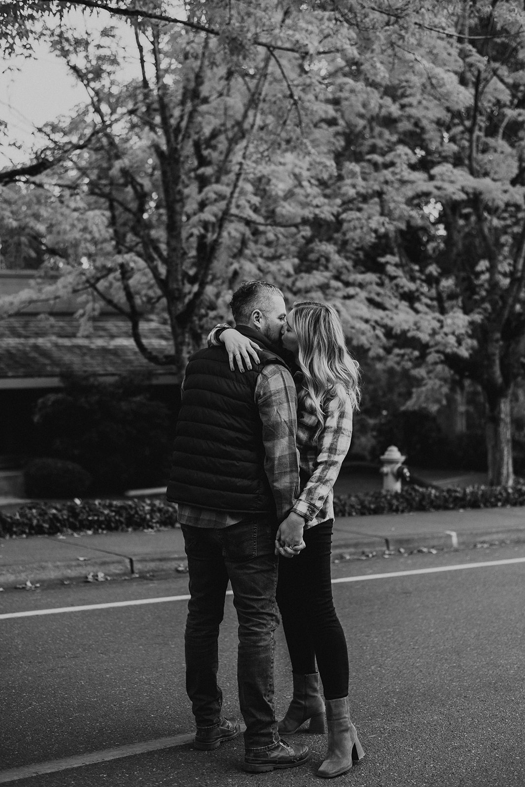 black and white photo of newly engaged couple kissing in Seattle during the fall 