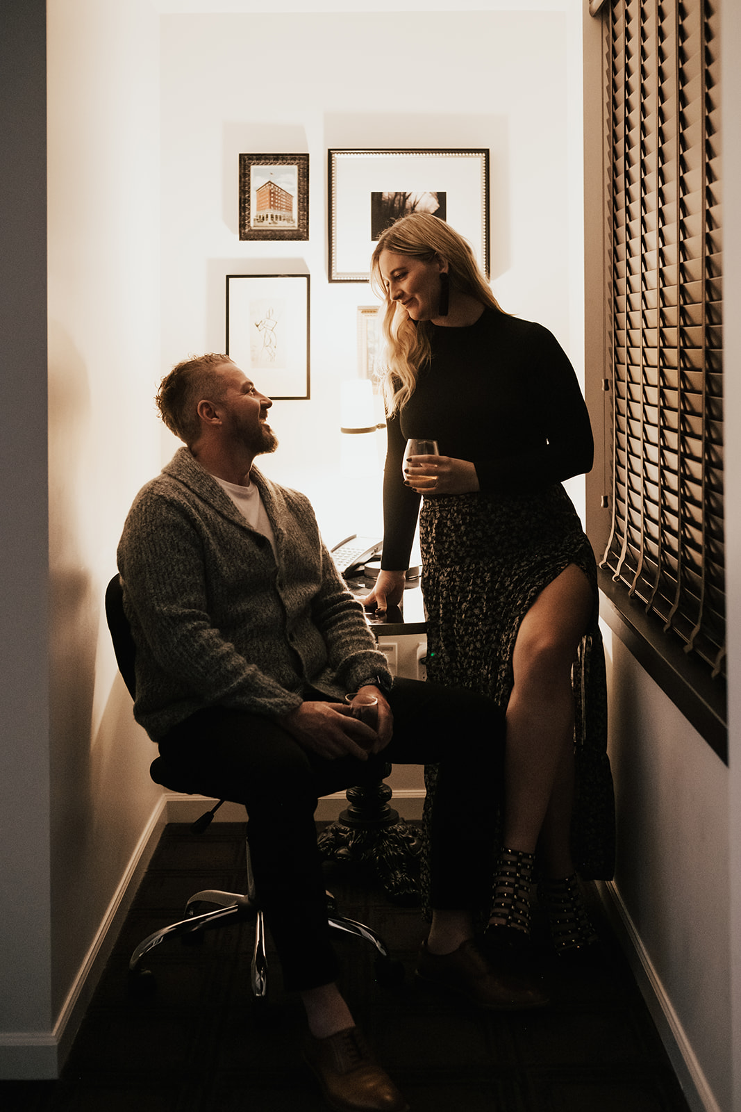 couple drinking in room in Art Deco inspired hotel during engagement photo shoot