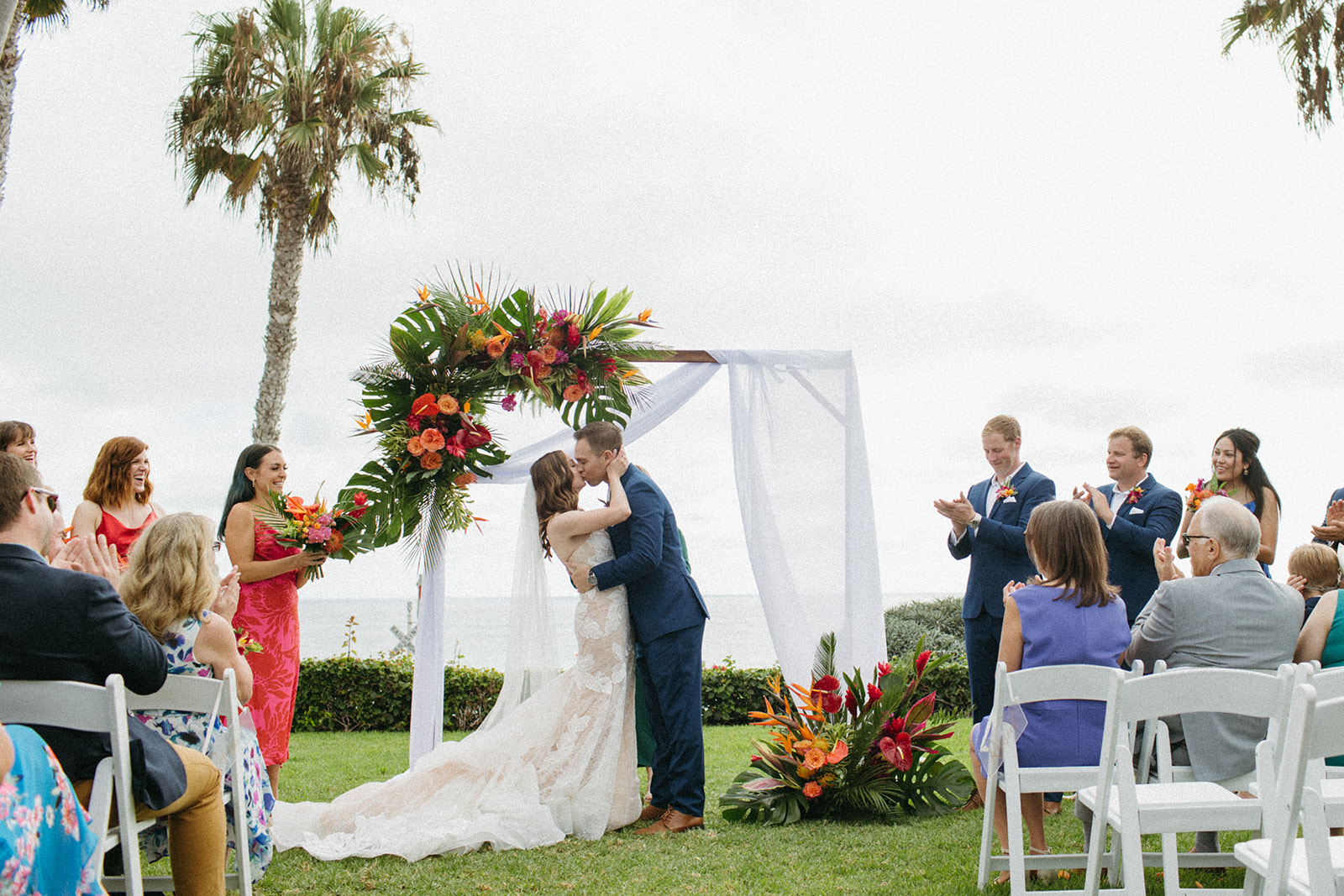 bride and groom first kiss during tropical wedding ceremony at Ole Hanson Beach Club
