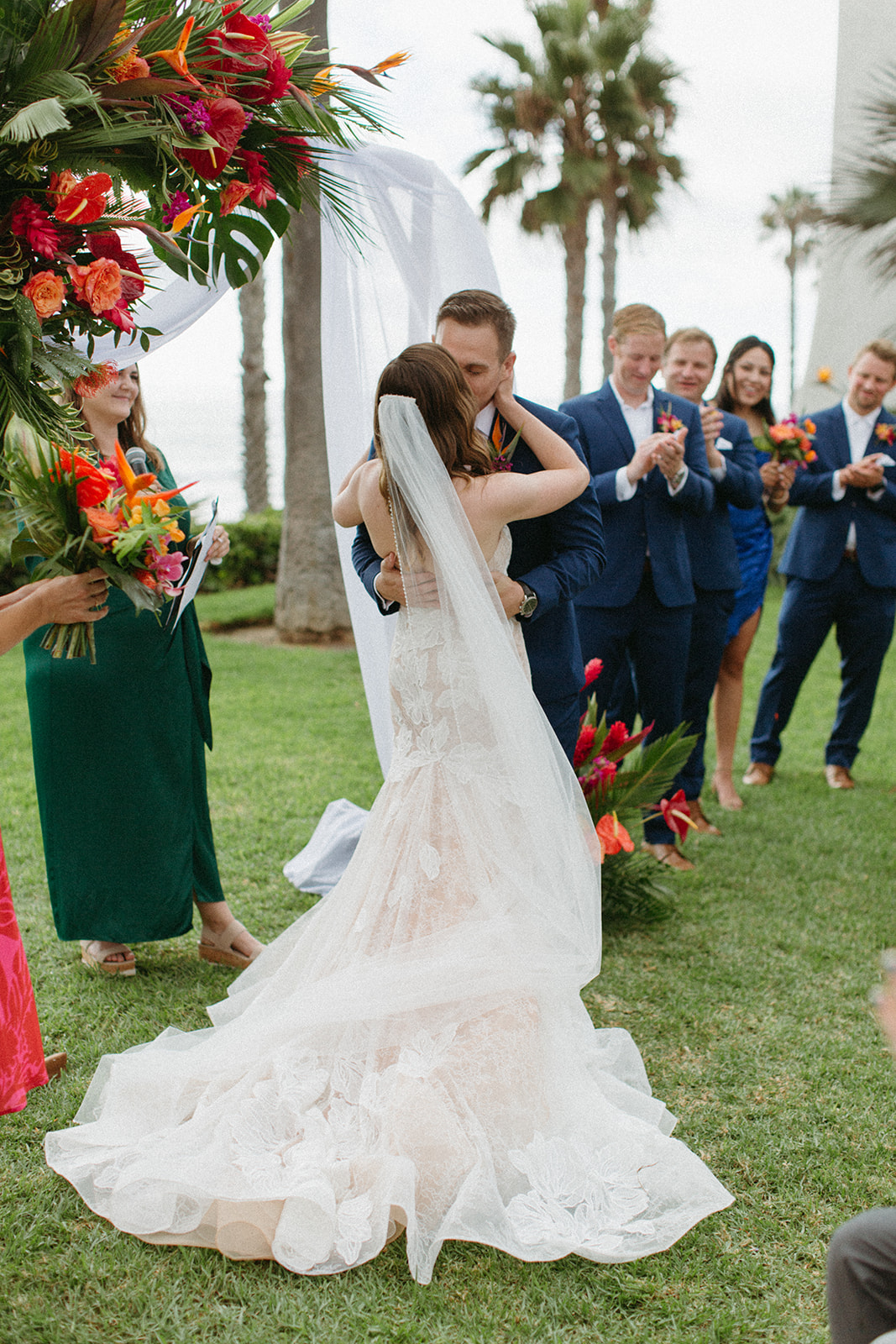bride and groom first kiss tropical wedding ceremony at Ole Hanson Beach Club
