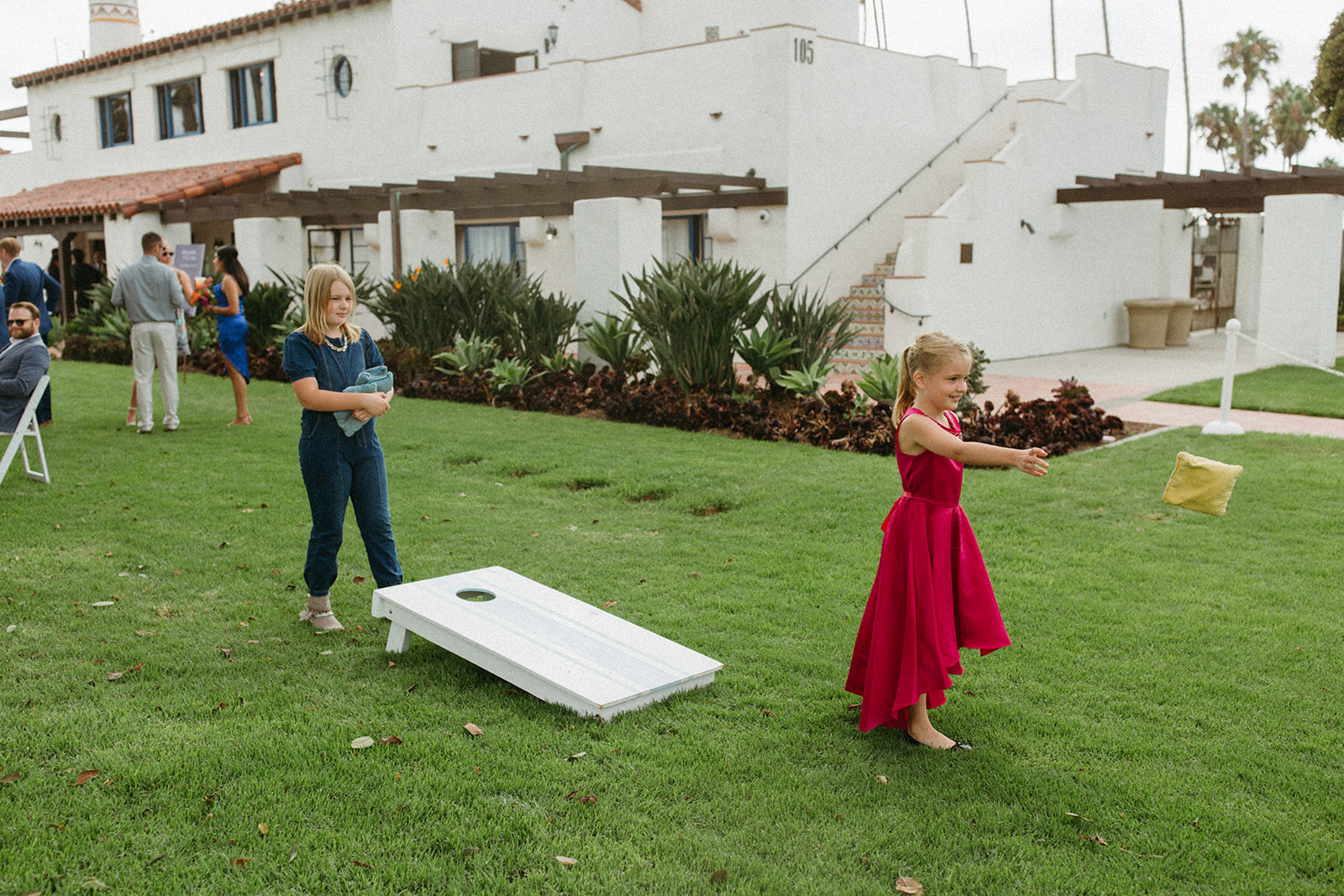 kids playing corn hole during cocktail hour
