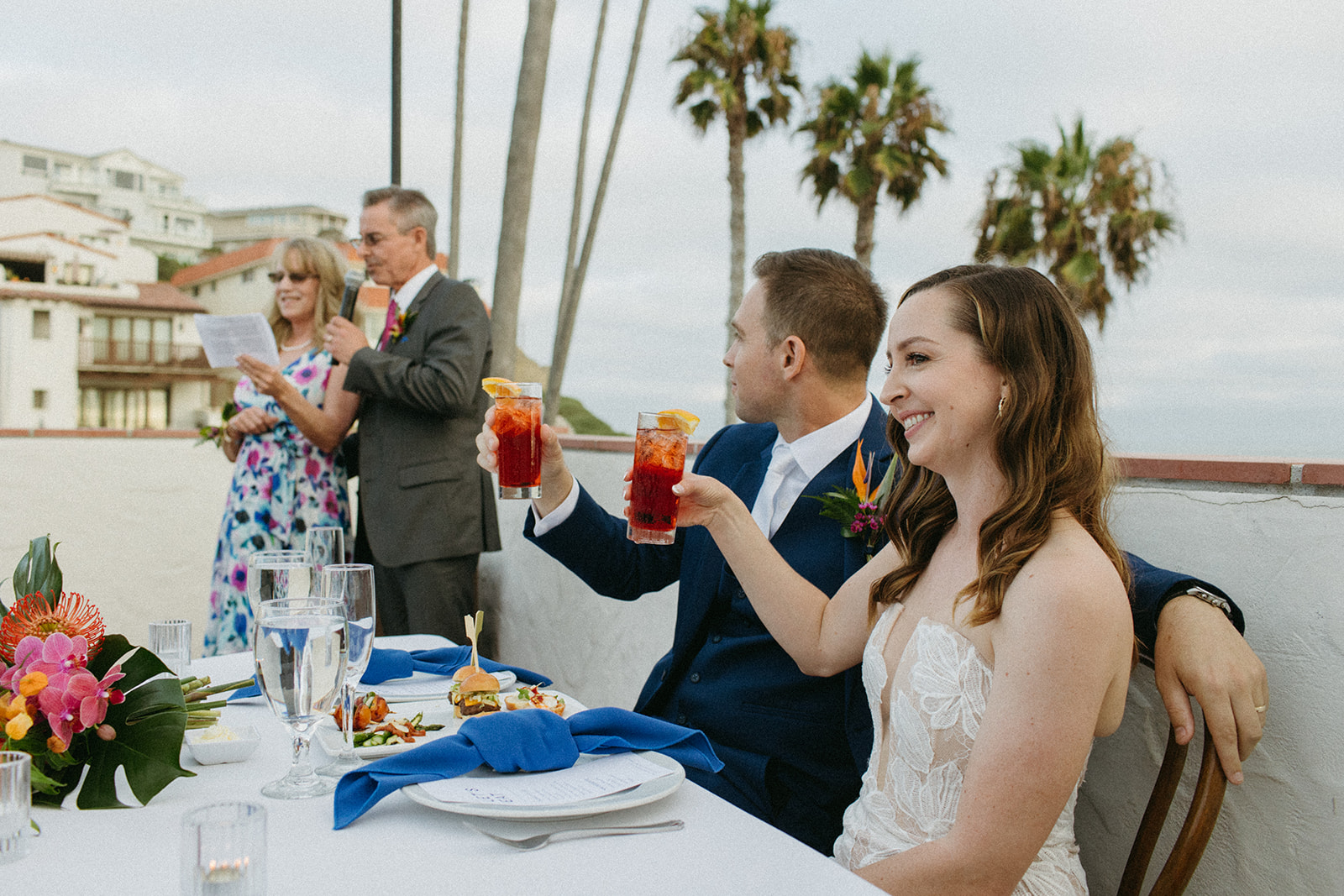 bride and groom raise a glass during toasts 
