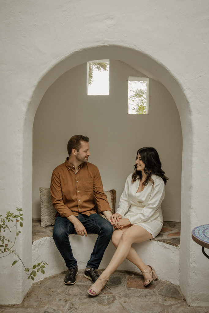 desert engagement photo session with bride in long sleeve silk mini dress and groom in brown button up