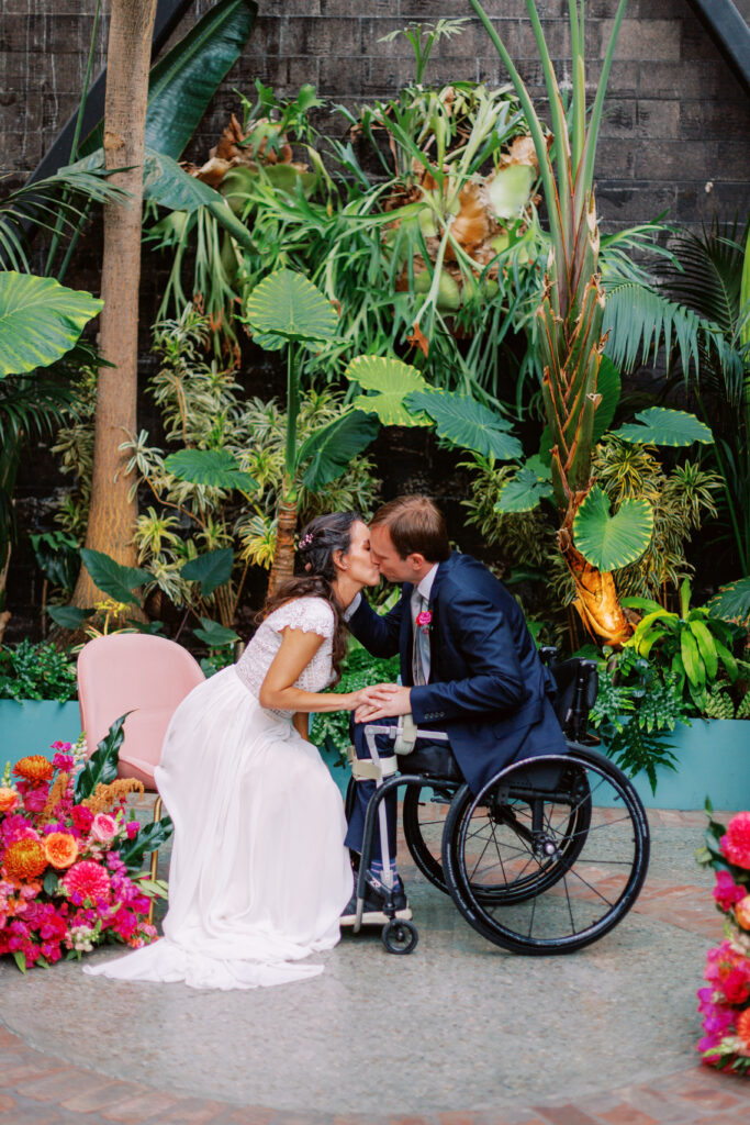 bride and groom share first kiss during fiesta themed wedding ceremony at Grass Room